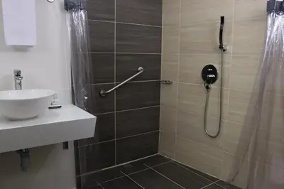 a bathroom with a shower and a sink at Arame Hotel in Envigado