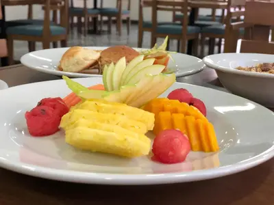 a plate of fruit and vegetables on a table at Arame Hotel in Envigado