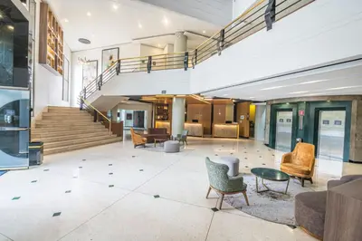 an open lobby with chairs and a staircase at Four Points by Sheraton Medellín in Medellín