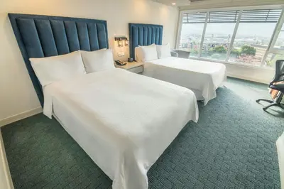 a hotel room with two beds and a window at Four Points by Sheraton Medellín in Medellín