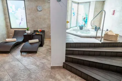 a bathroom with a bath tub and a table and chairs at Four Points by Sheraton Medellín in Medellín