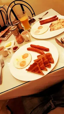 a table with two plates of breakfast food on it at 61Prado Hotel in Medellín