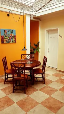 a dining room with a wooden table and chairs at 61Prado Hotel in Medellín