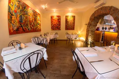 a restaurant with tables and chairs in a room at 61Prado Hotel in Medellín