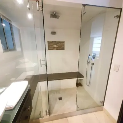 a shower with a glass door in a bathroom at Apartamentos Poblado Alejandría by HOUSY in Medellín
