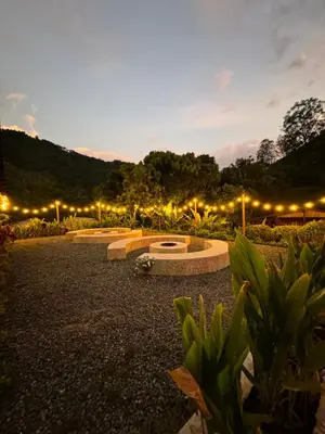a row of benches in a park at night at Hotel Campestre la Playa in Betania