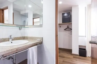 a bathroom with a sink and a mirror at Hotel Florencia Plaza in Medellín