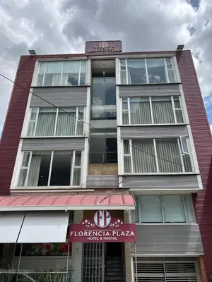 a tall building with a sign on the side of it at Hotel Florencia Plaza in Medellín