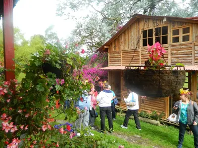 a group of people standing outside of a house at Finca Hotel Nutabes in San Pedro