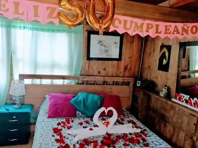 a bedroom with a bed with a couple of swans on it at Finca Hotel Nutabes in San Pedro