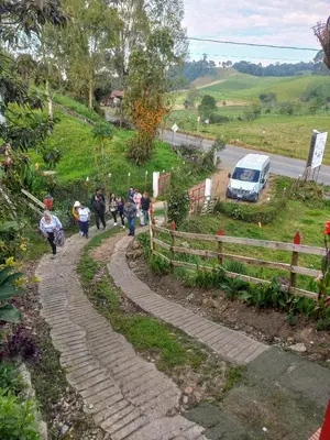 a group of people walking down a road at Finca Hotel Nutabes in San Pedro