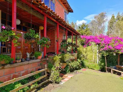 a building with lots of plants and flowers on it at Finca Hotel Nutabes in San Pedro
