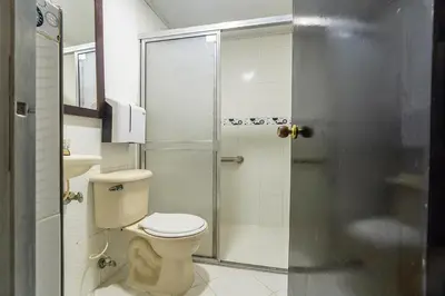a bathroom with a toilet and a shower at Hotel Barcelona Estadio in Medellín