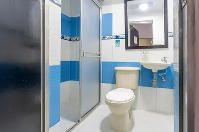 a bathroom with a toilet and a sink at Hotel Barcelona Estadio in Medellín
