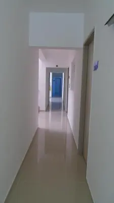 an empty hallway in a building with white walls and floors at Hotel Suite del Parque in Medellín