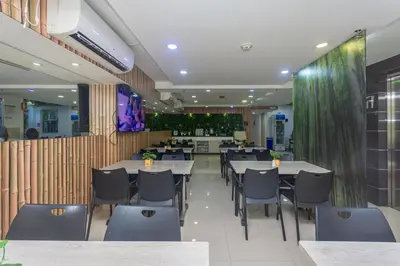 a restaurant with tables and chairs in a room at Hotel Suite del Parque in Medellín