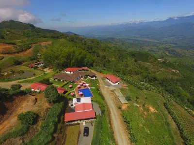 an aerial view of a house on a hill at Finca Hotel Los Guayacanes in San JosÃ©