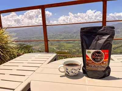 a cup of coffee sitting on a table with a bag of coffee at Finca Hotel Los Guayacanes in San JosÃ©