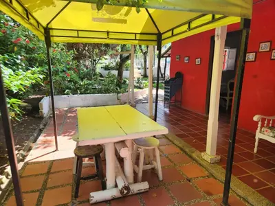 a table and chairs under a tent on a patio at Hosteria El Castellano in Santa Fe de Antioquia
