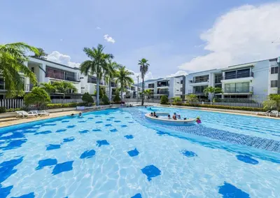 a large swimming pool in front of a building at Apartasol Santafe de Antioquia in Santa Fe de Antioquia