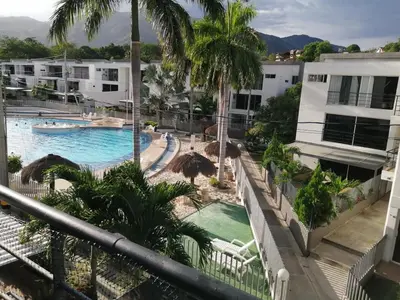a view of the pool from the balcony of a resort at Apartasol Santafe de Antioquia in Santa Fe de Antioquia