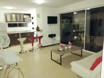 a living room with a couch and a table at Apartasol Santafe de Antioquia in Santa Fe de Antioquia
