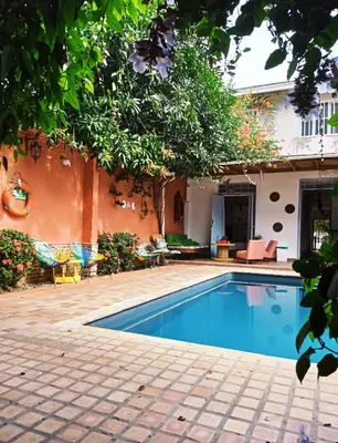 a swimming pool in front of a house at Hotel Casa de Verano - Solo adultos - in Santa Fe de Antioquia
