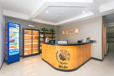 a restaurant with a counter in a store at Mandala Medellín Belén By GyC Hotels in Medellín