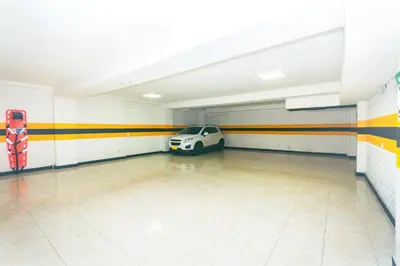 a garage with a car parked in it at Mandala Medellín Belén By GyC Hotels in Medellín