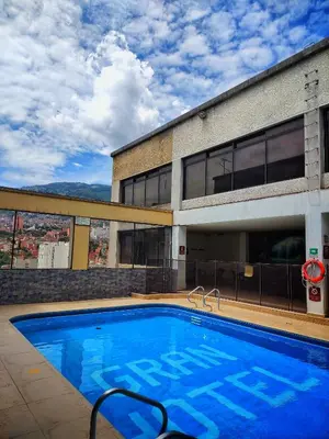 a large swimming pool in front of a building at Gran Hotel in Medellín