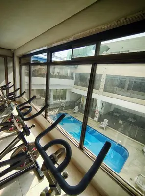 a gym with a view of a swimming pool at Gran Hotel in Medellín