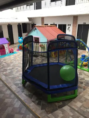 a play structure with a green ball in a playground at Hotel Ozzy in Doradal