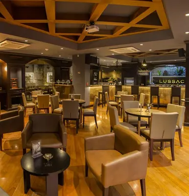 a restaurant with tables and chairs and a bar at Hotel Park10 in Medellín
