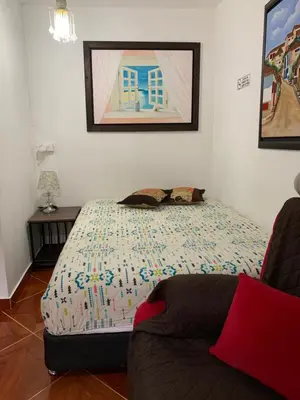 a bedroom with a bed and a couch in it at Casa Huespedes EL ENSUEÑO in Jardin