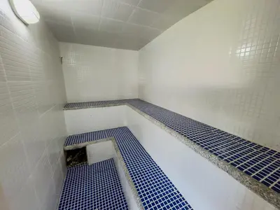 a bathroom with blue and white tiled walls and a shower at Hotel Alcaravan Medellín in Medellín
