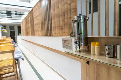 a bar in a restaurant with a machine on a counter at Hotel Alcaravan Medellín in Medellín