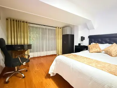 a bedroom with a bed and a desk and a chair at Hotel Veler in Medellín