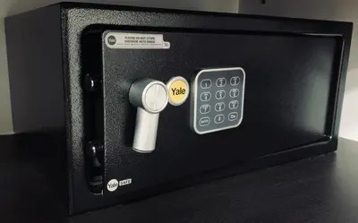 a small microwave with a remote control on a table at Hotel Veler in Medellín