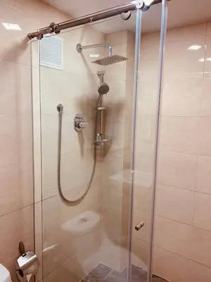 a shower with a glass door in a bathroom at Hotel Veler in Medellín