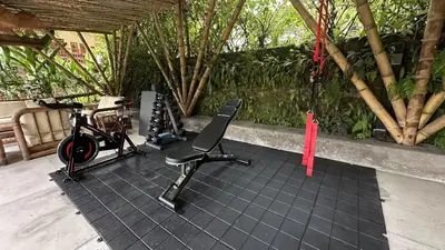 a room with a bike and a chair on a tile floor at Lodge Paraíso Verde in Manizales