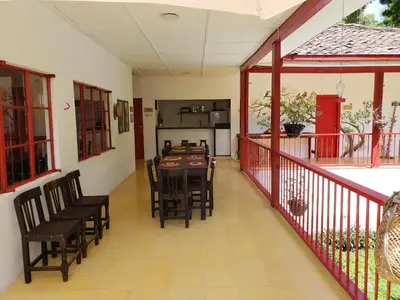 a dining room with a table and chairs on a balcony at Lodge Paraíso Verde in Manizales