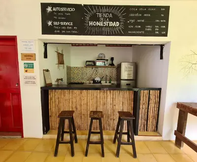 a restaurant with two stools in front of a counter at Lodge Paraíso Verde in Manizales