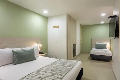 a bedroom with two beds in a room at Hotel Suite Comfort in Medellín