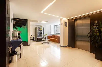 a living room with a couch and a table at Hotel Suite Comfort in Medellín