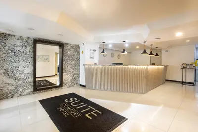 a lobby with a bar with a sign on the floor at Hotel Suite Comfort in Medellín