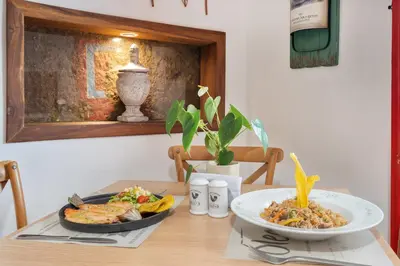a table with a plate of food and a bowl of food at Casa Passiflora Hotel Boutique - Jardín in Jardin