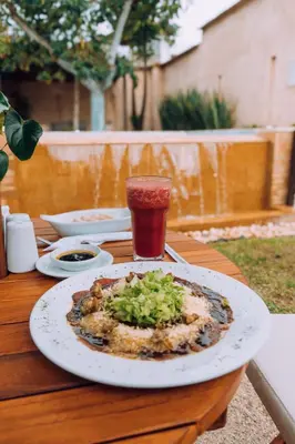 a plate of food on a table with a drink at Casa Passiflora Hotel Boutique - Jardín in Jardin