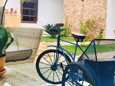 a blue bike parked next to a chair at Casa Passiflora Hotel Boutique - Jardín in Jardin