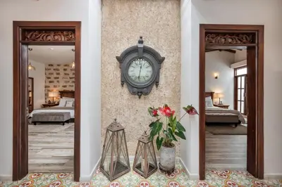 a clock on the wall of a room with a bedroom at Casa Passiflora Hotel Boutique - Jardín in Jardin