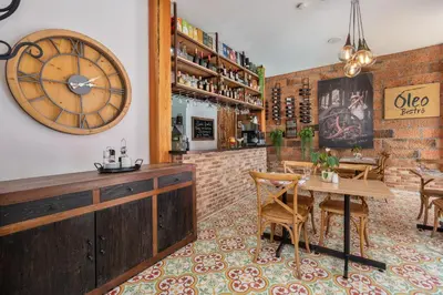 a restaurant with a table and a clock on the wall at Casa Passiflora Hotel Boutique - Jardín in Jardin